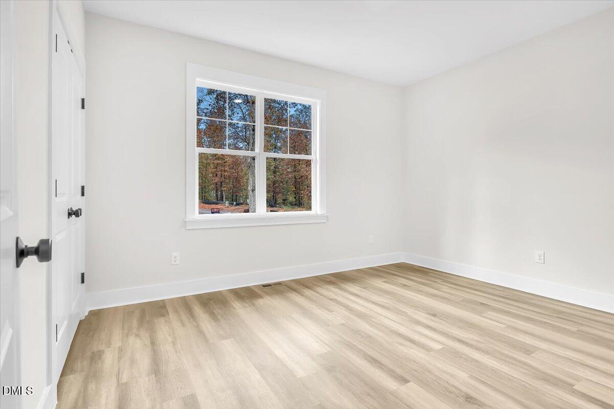 12916 Mallard Rock Road Zebulon, NC 27597 - Photo 26 of 68 a view of empty room with windows