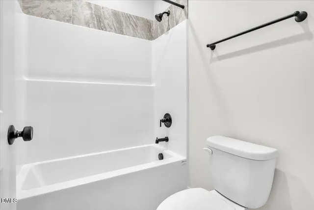 a front view of a house with yard and green space