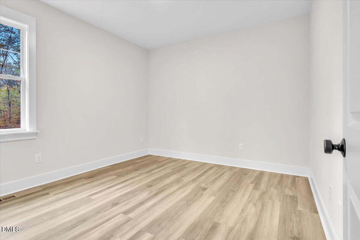 12916 Mallard Rock Road Zebulon, NC 27597 - Photo 30 of 68 a view of a room with wooden floor and a window
