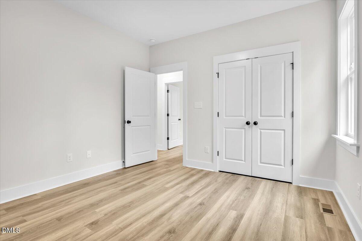 12916 Mallard Rock Road Zebulon, NC 27597 - Photo 31 of 68 a view of empty room with wooden floor