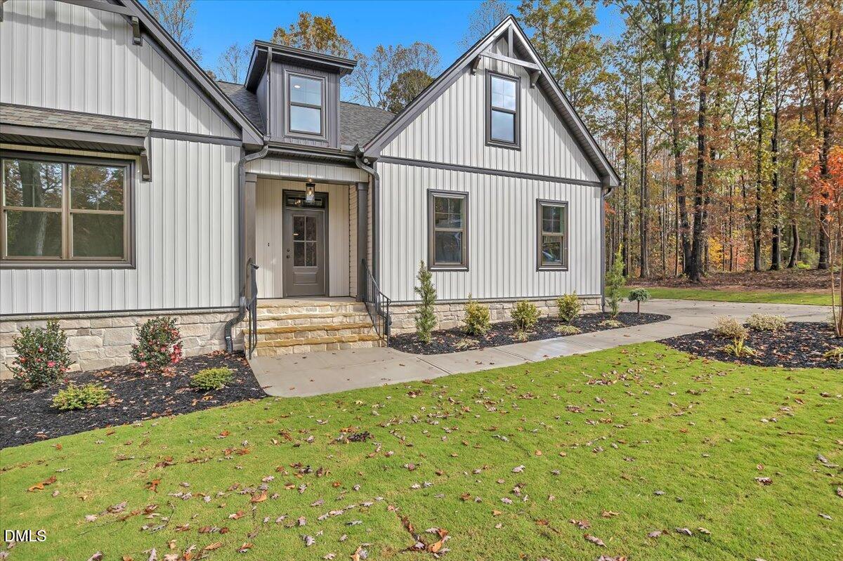 12916 Mallard Rock Road Zebulon, NC 27597 - Photo 48 of 68 a front view of a house with yard and green space