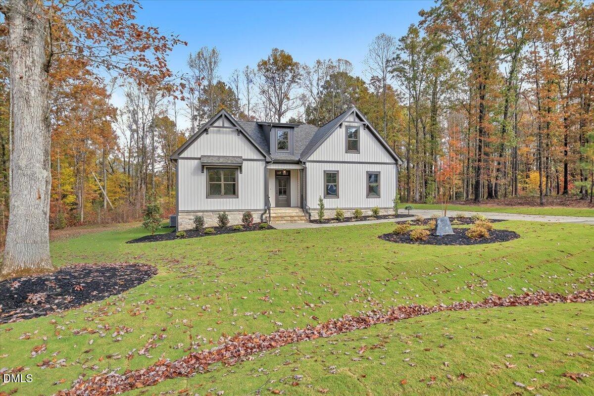 12916 Mallard Rock Road Zebulon, NC 27597 - Photo 52 of 68 a front view of a house with garden