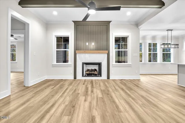 a large kitchen with kitchen island a sink a center island stainless steel appliances and a window