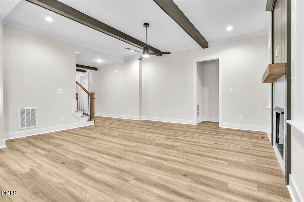 12916 Mallard Rock Road Zebulon, NC 27597 - Photo 67 of 68 a view of an empty room with wooden floor and a window