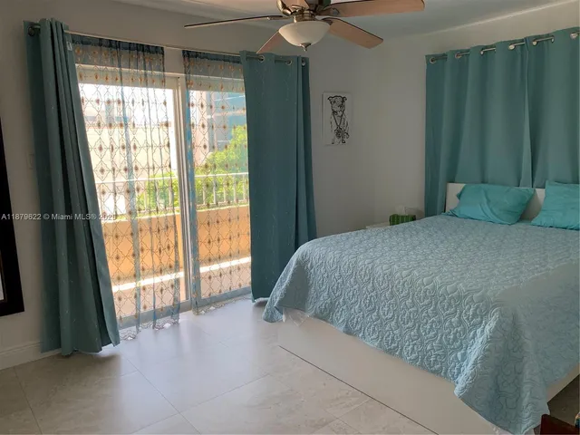 a bedroom with a large bed and a large window