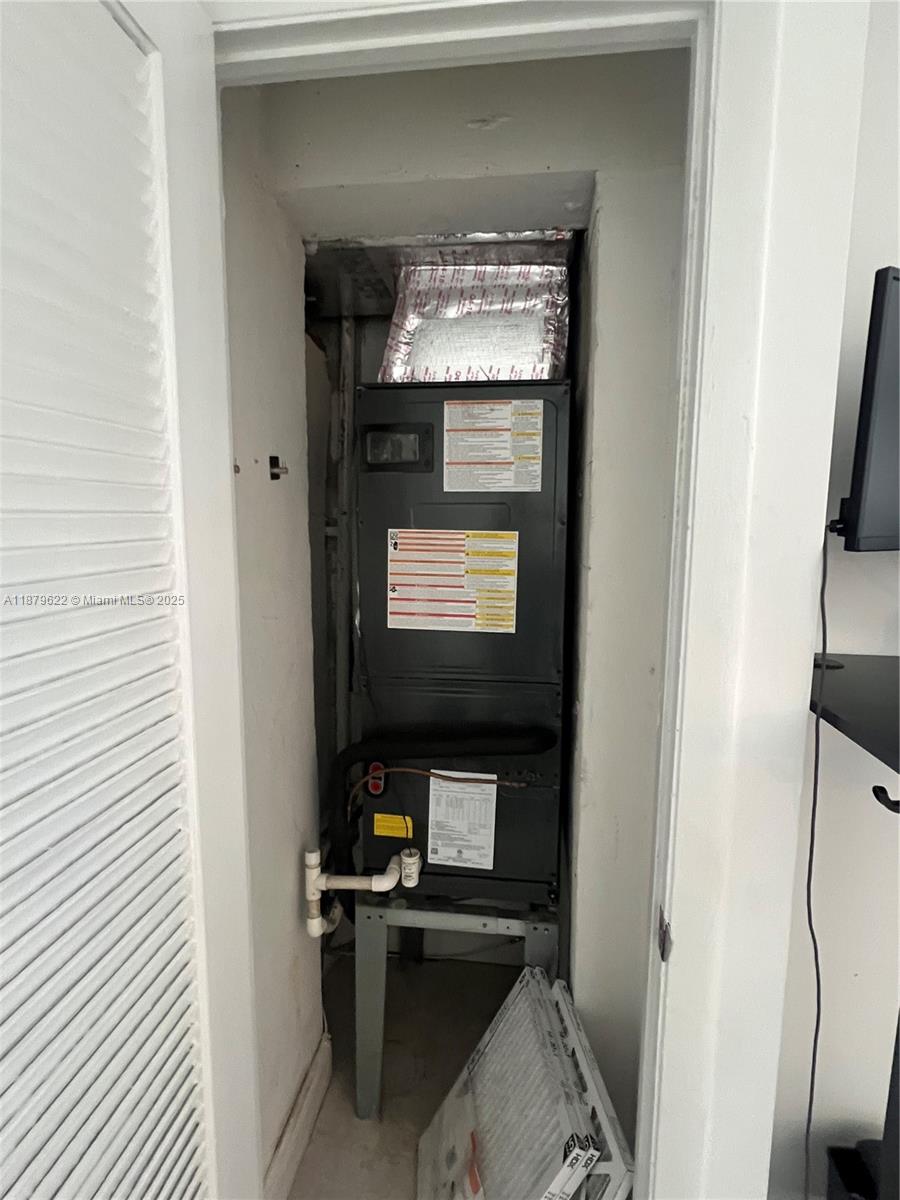 3304 Virginia Street, Unit 6C Miami, FL 33133 - Photo 15 of 22 a living room with a fireplace and a flat screen tv