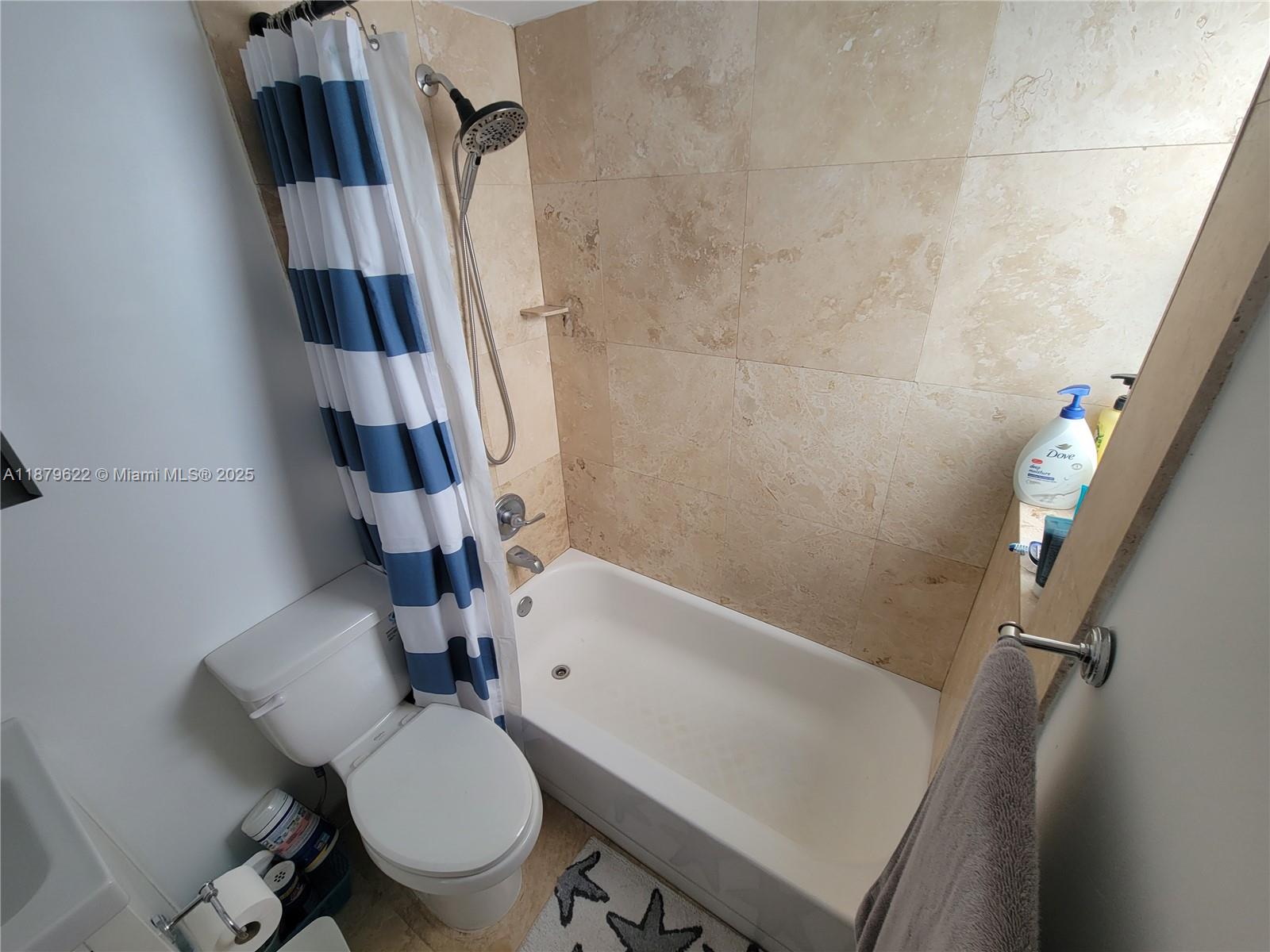 3304 Virginia Street, Unit 6C Miami, FL 33133 - Photo 16 of 22 a bathroom with a sink a toilet a tub and shower