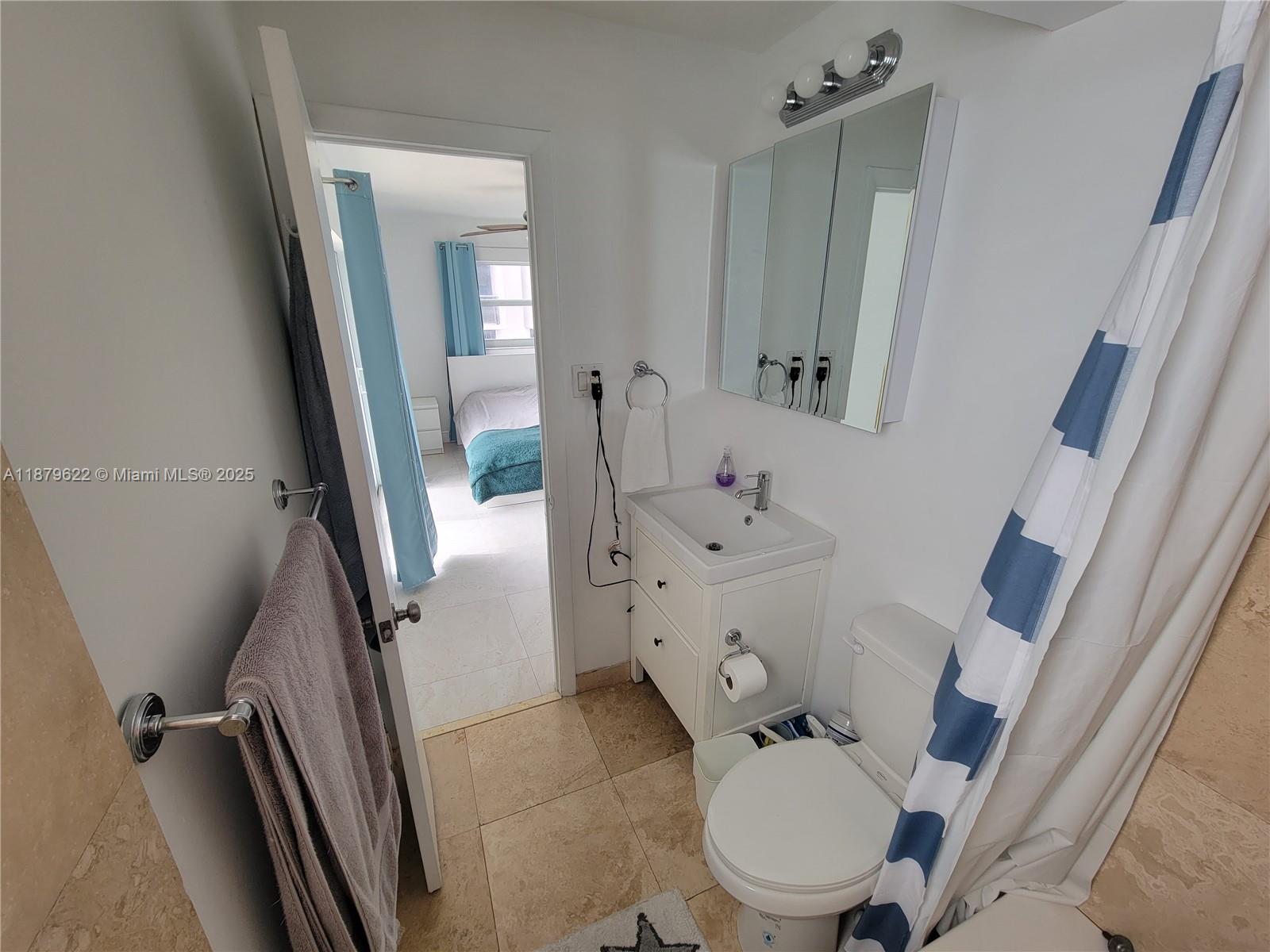 3304 Virginia Street, Unit 6C Miami, FL 33133 - Photo 17 of 22 a bathroom with a toilet sink and mirror