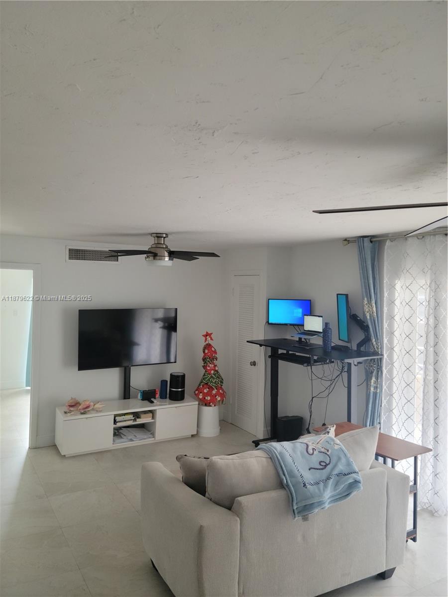 3304 Virginia Street, Unit 6C Miami, FL 33133 - Photo 3 of 22 a living room with furniture and a flat screen tv