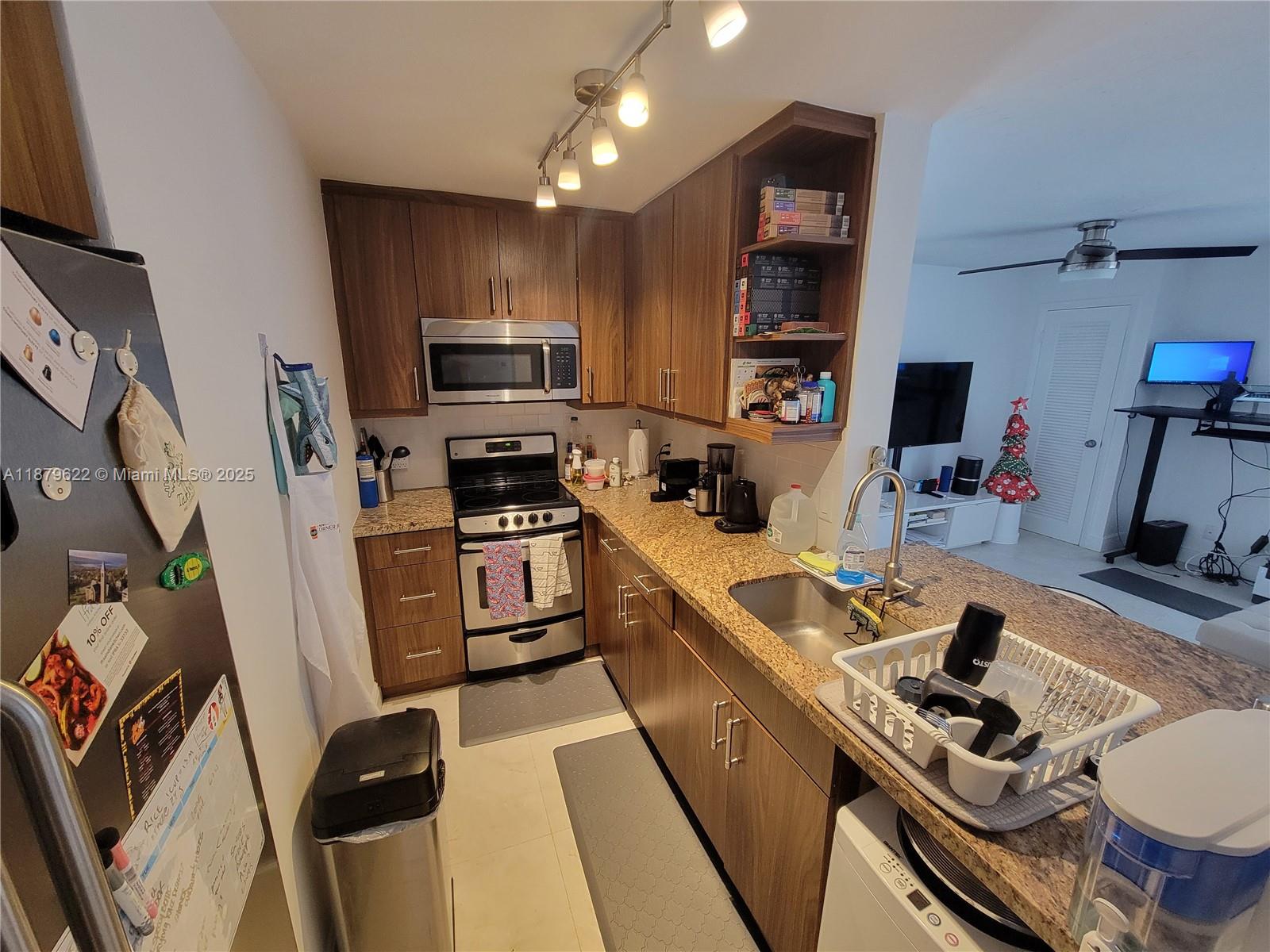 3304 Virginia Street, Unit 6C Miami, FL 33133 - Photo 6 of 22 a kitchen that has a sink and a stove top oven