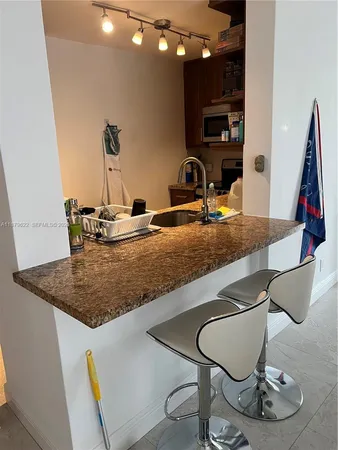 a kitchen with a table and chairs