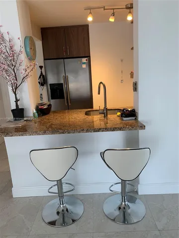 a kitchen with refrigerator and sink