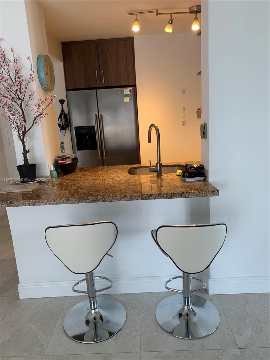 3304 Virginia Street, Unit 6C Miami, FL 33133 - Photo 10 of 22 a kitchen with refrigerator and sink