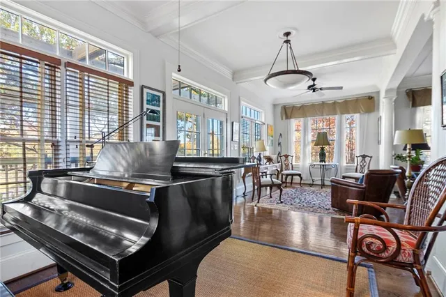 a living room with dining room and wooden floor