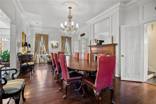 a view of a dining room with furniture wooden floor and chandelier