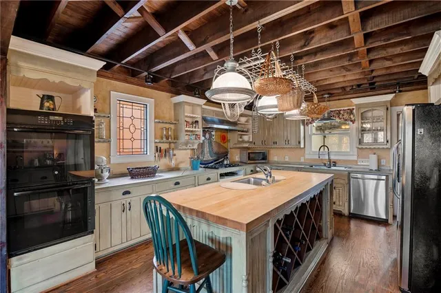 a kitchen with a stove a sink and a refrigerator