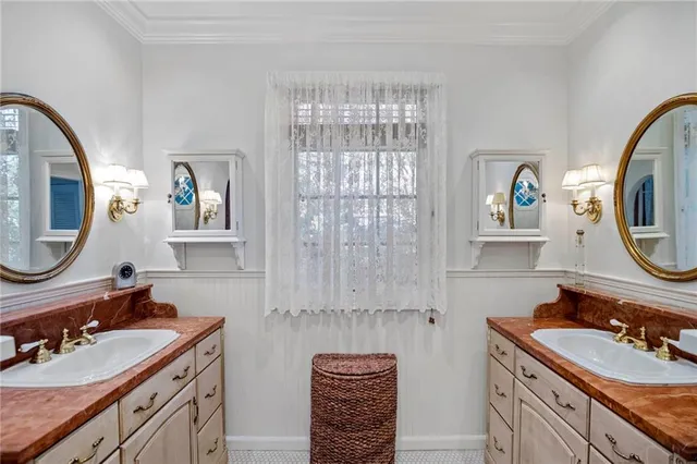 a bathroom with a sink mirror and vanity
