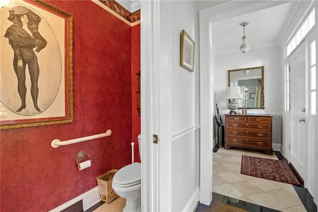 a bathroom with a toilet a sink and mirror