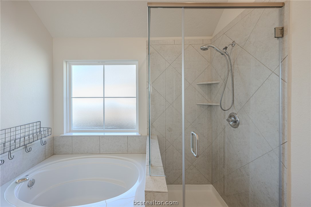 1012 Old Vine Road Brenham, TX 77833 - Photo 16 of 22 a bathroom with a tub and shower