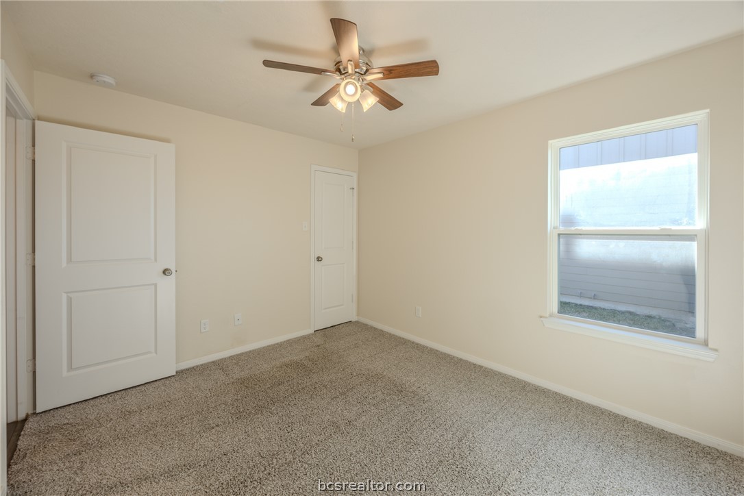 1012 Old Vine Road Brenham, TX 77833 - Photo 21 of 22 an empty room with a window and a fan