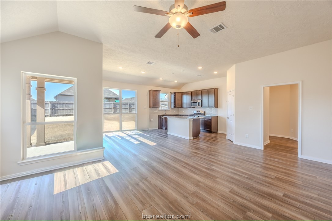 1012 Old Vine Road Brenham, TX 77833 - Photo 7 of 22 a view of a kitchen with wooden floor and a window