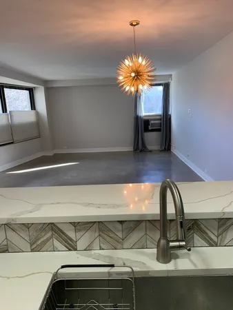a kitchen with a sink and chandelier