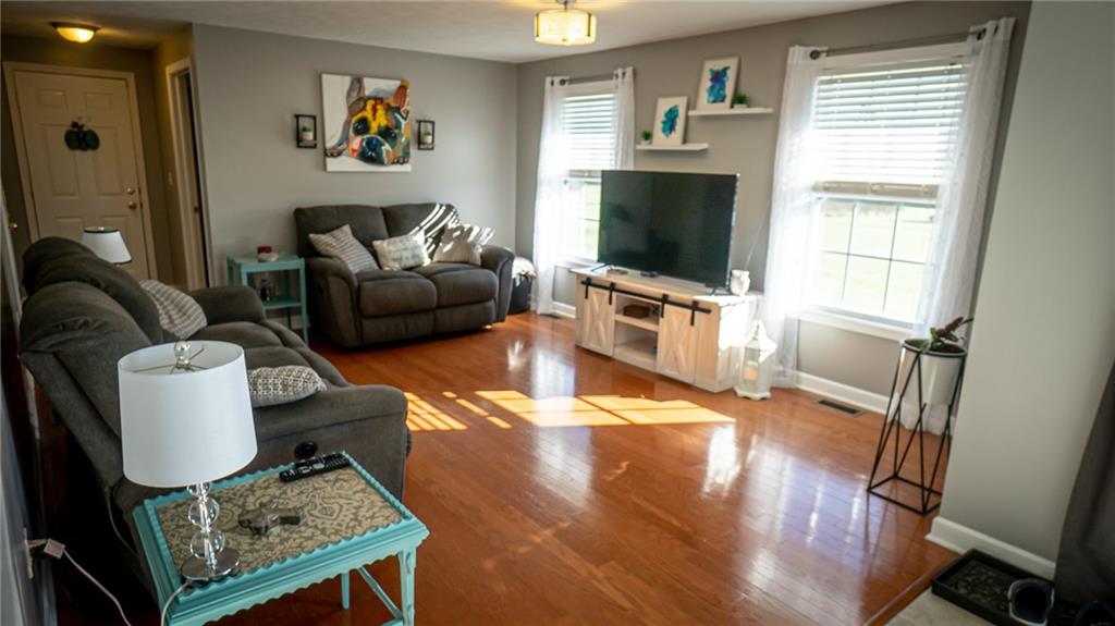 669 Unionville Road Butler, PA 16001 - Photo 2 of 21 a living room with furniture and a flat screen tv