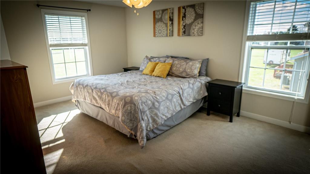 669 Unionville Road Butler, PA 16001 - Photo 13 of 21 a bed sitting in a bedroom next to a window
