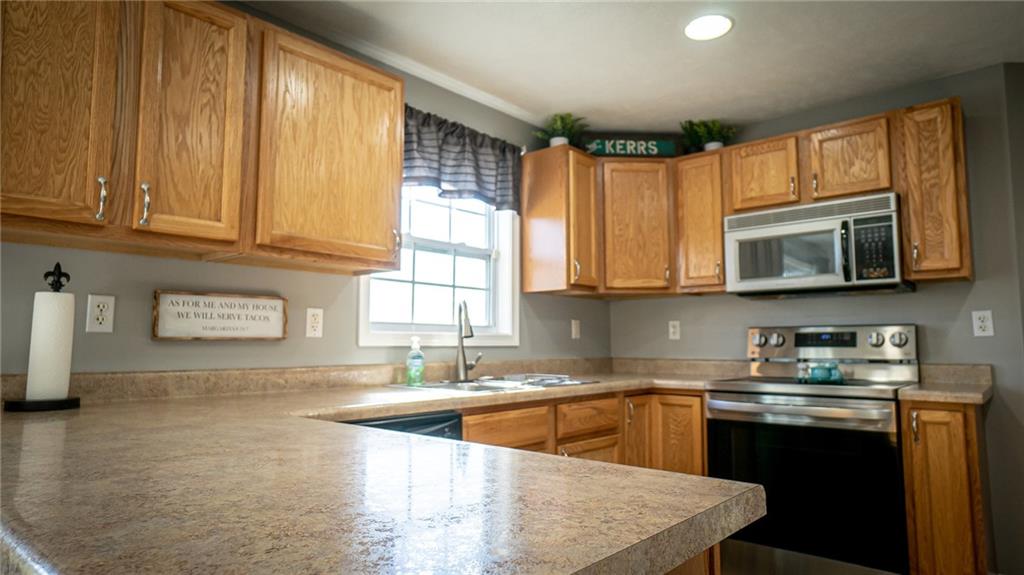 669 Unionville Road Butler, PA 16001 - Photo 8 of 21 a kitchen with stainless steel appliances granite countertop a sink a stove and cabinets