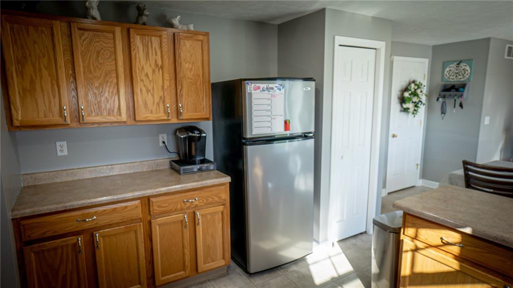 669 Unionville Road Butler, PA 16001 - Photo 9 of 21 a kitchen with a refrigerator and cabinets