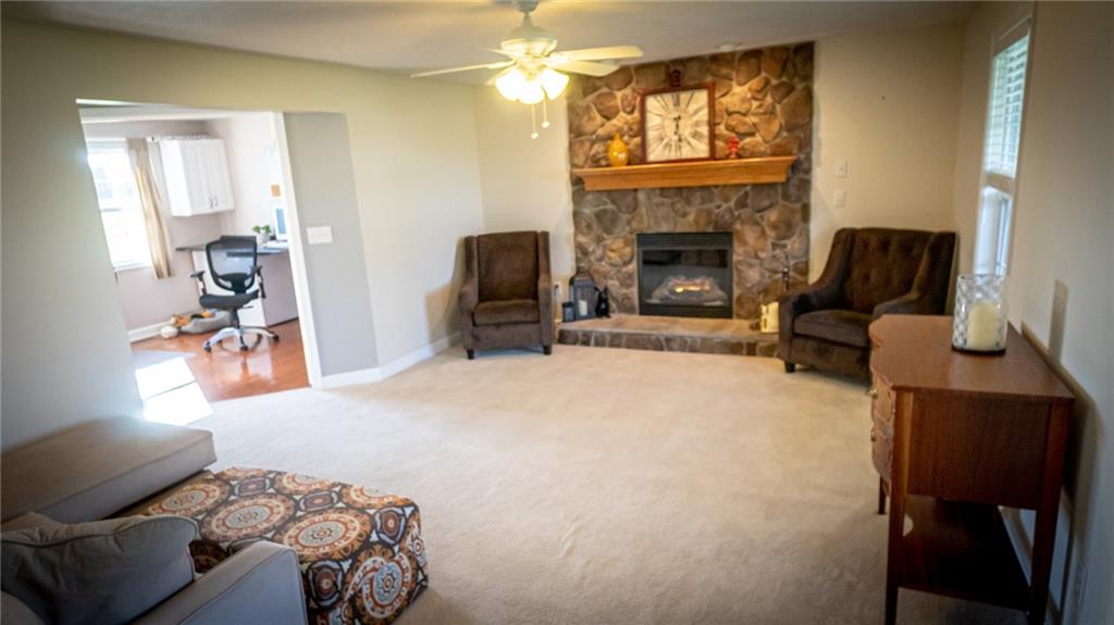 669 Unionville Road Butler, PA 16001 - Photo 10 of 21 a living room with furniture a fireplace and a flat screen tv