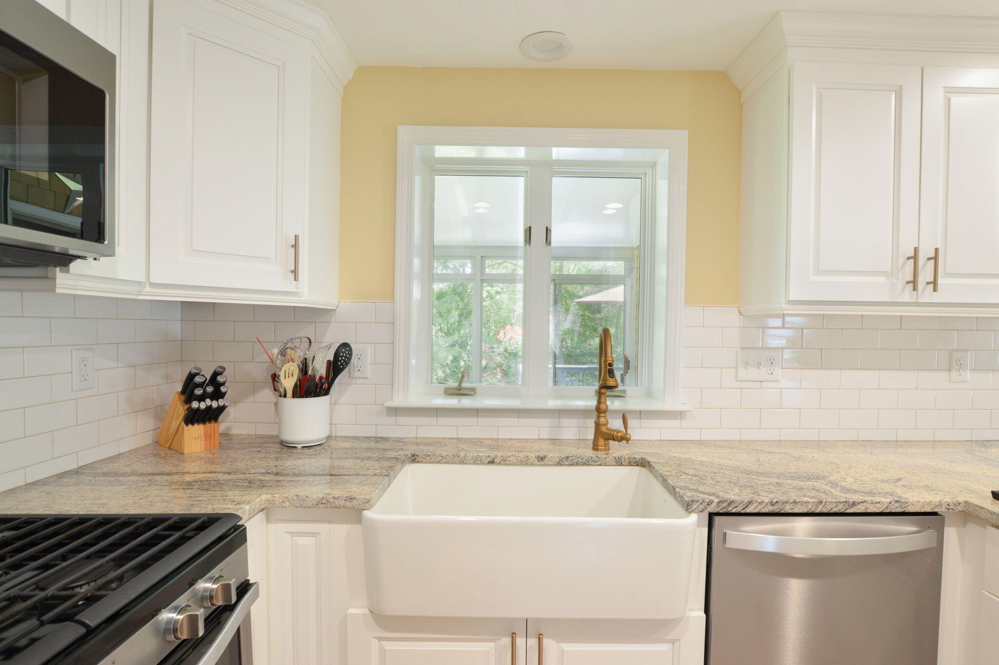 48 Hogan Drive Mashpee, MA 02649 - Photo 16 of 36 a kitchen with a sink stove and cabinets