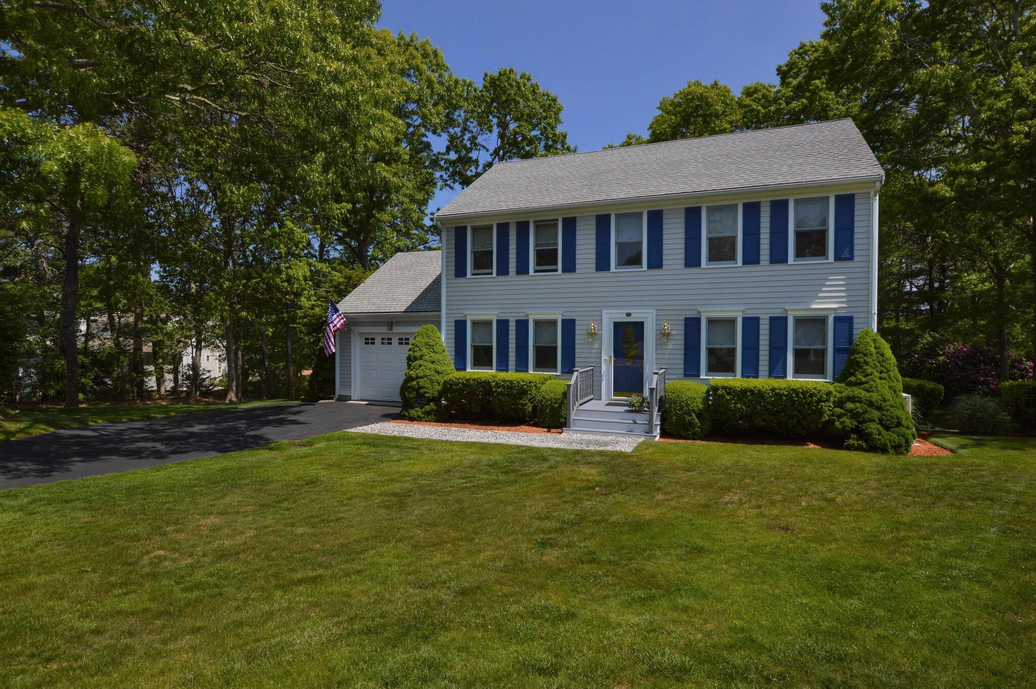 48 Hogan Drive Mashpee, MA 02649 - Photo 2 of 36 a view of a house next to a big yard and large trees