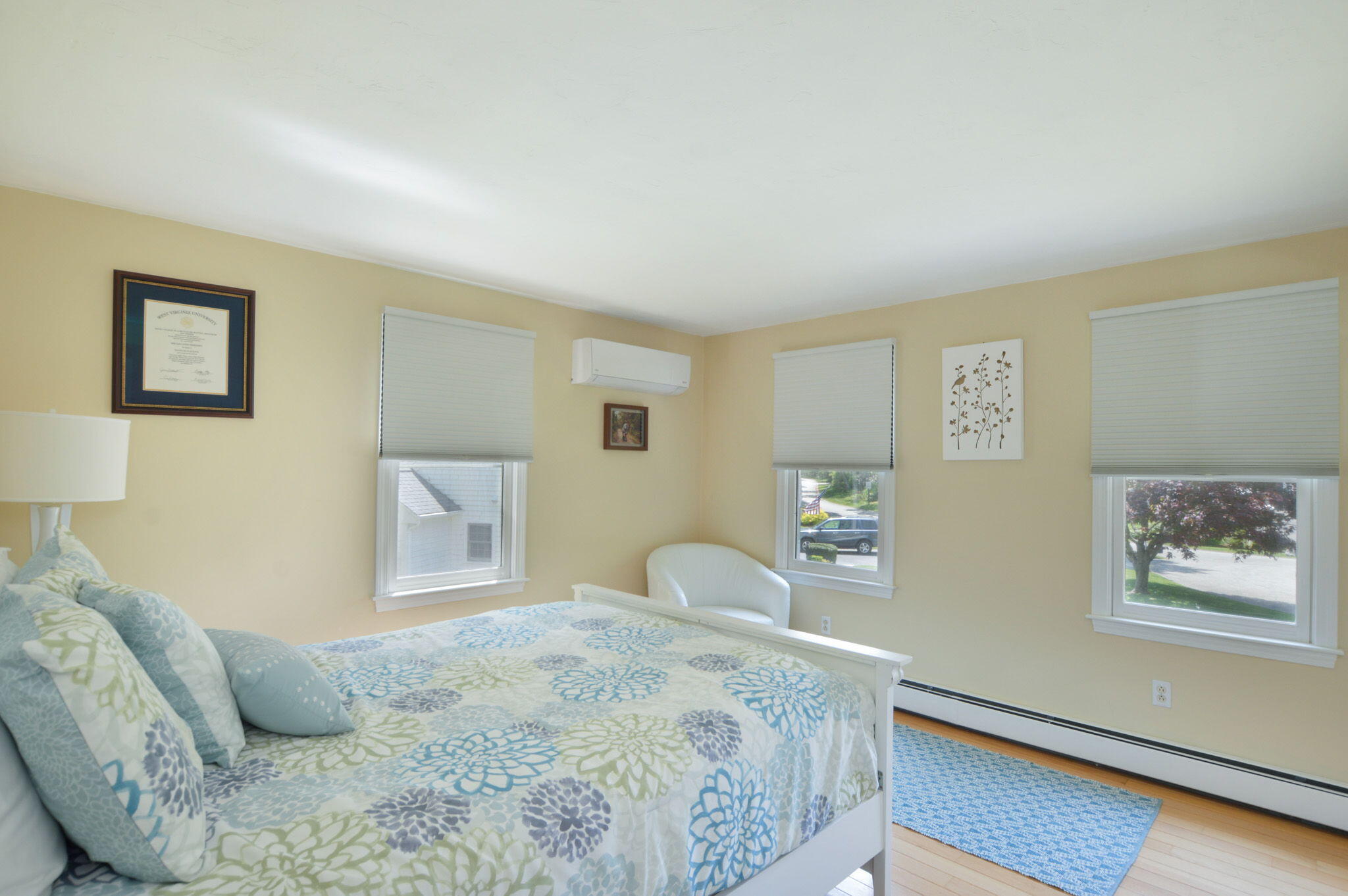 48 Hogan Drive Mashpee, MA 02649 - Photo 25 of 36 a bedroom with a bed and painting on the wall