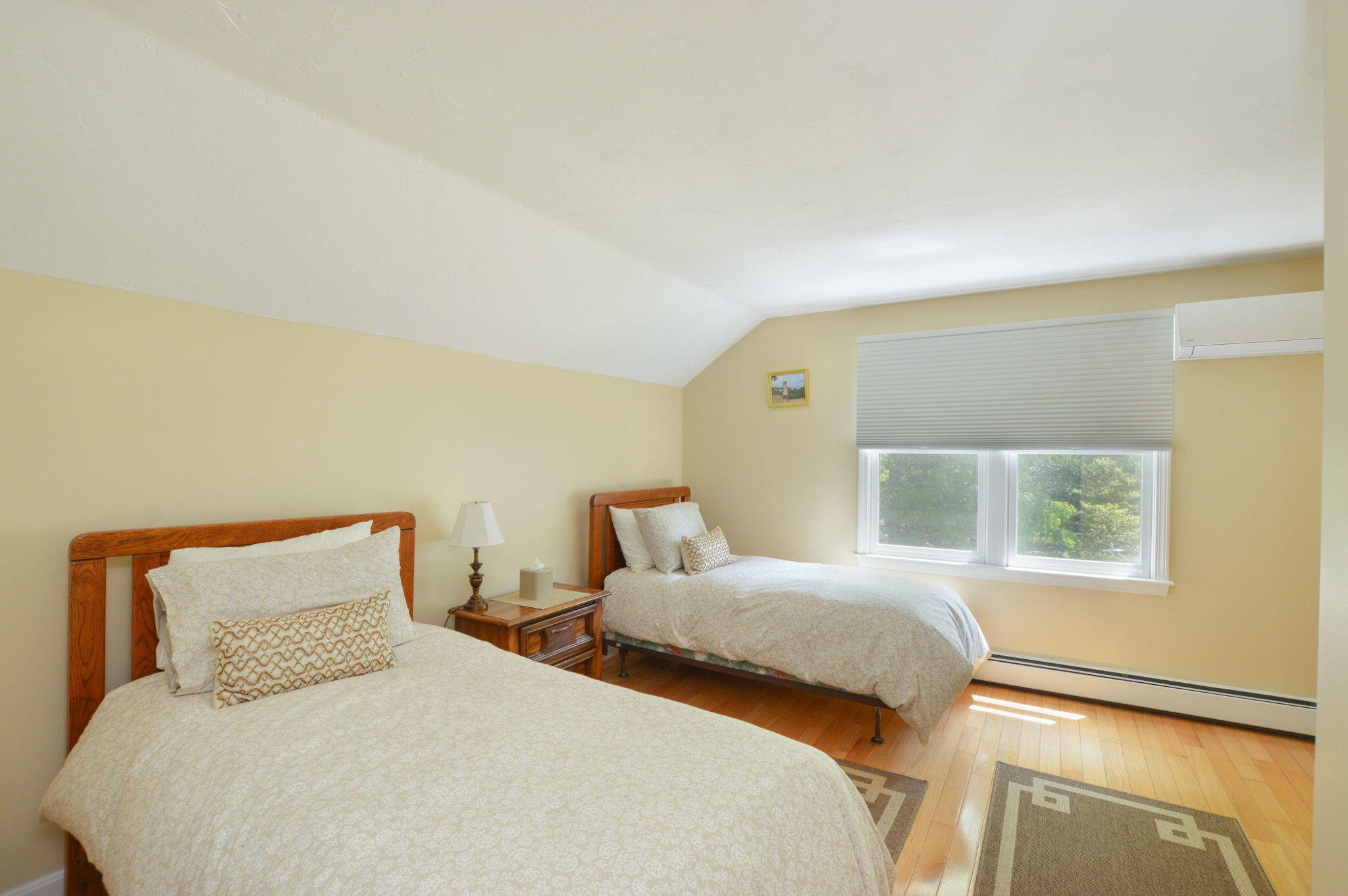 48 Hogan Drive Mashpee, MA 02649 - Photo 26 of 36 a bedroom with two beds and a potted plant next to a window