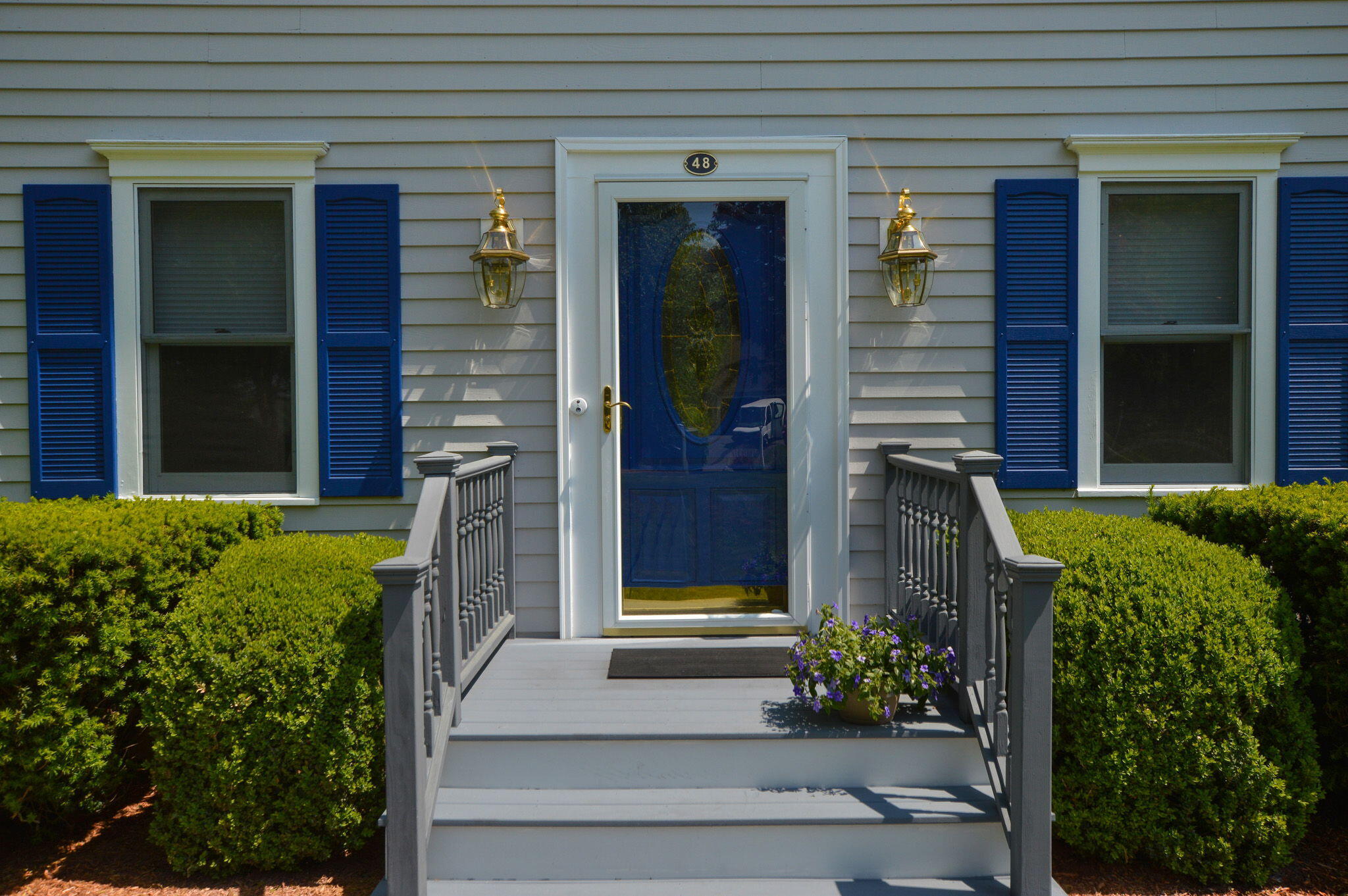 48 Hogan Drive Mashpee, MA 02649 - Photo 3 of 36 a front view of a house with a garden