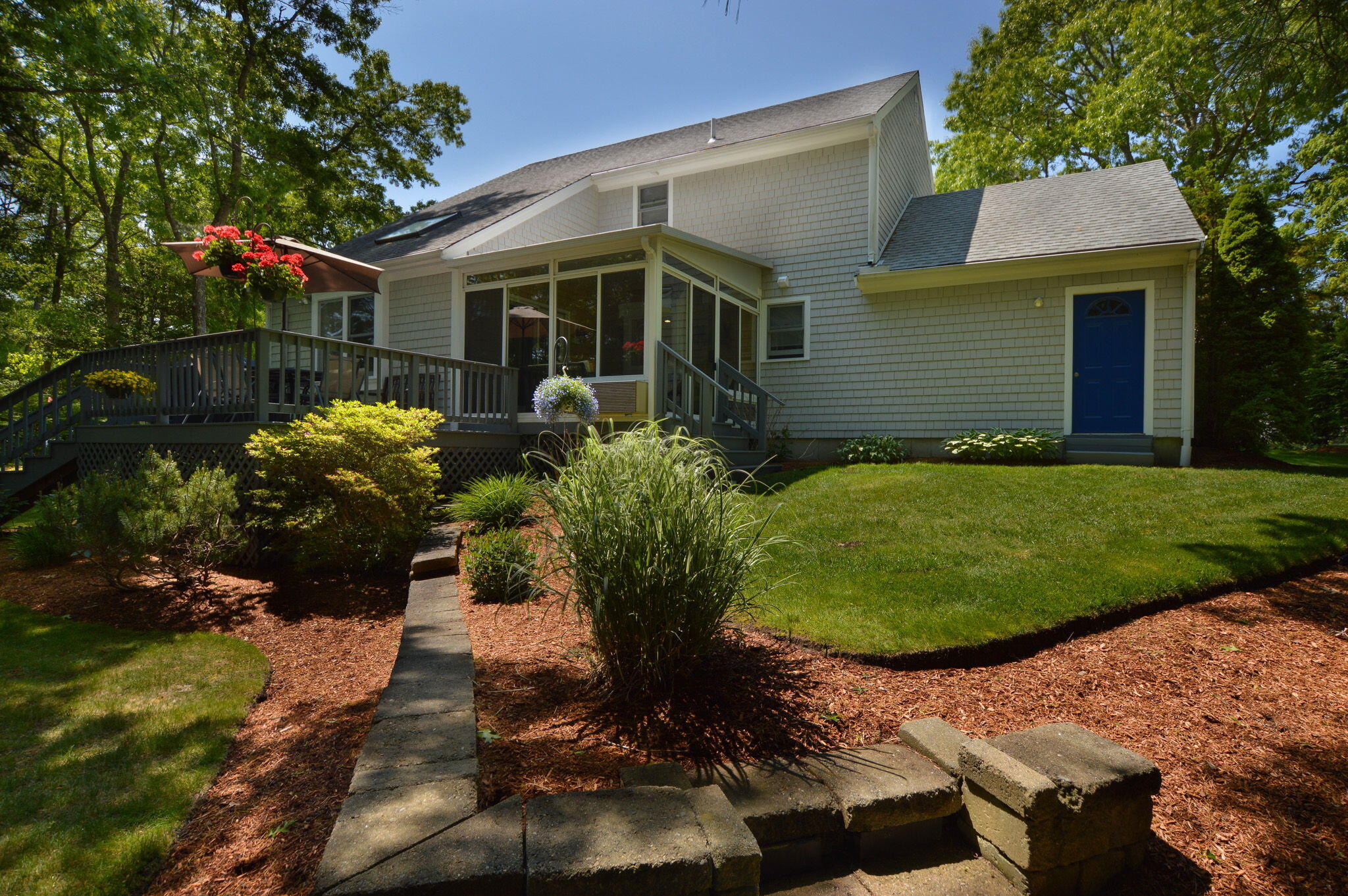 48 Hogan Drive Mashpee, MA 02649 - Photo 4 of 36 a white house with a yard and a garden