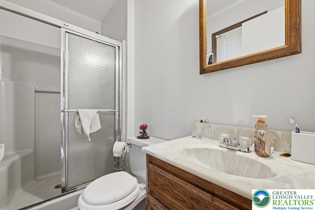 520 Highland Hill Road Jim Thorpe, PA 18235 - Photo 32 of 83 Functional bathroom featuring a shower with sliding doors and a vanity with an integrated sink.