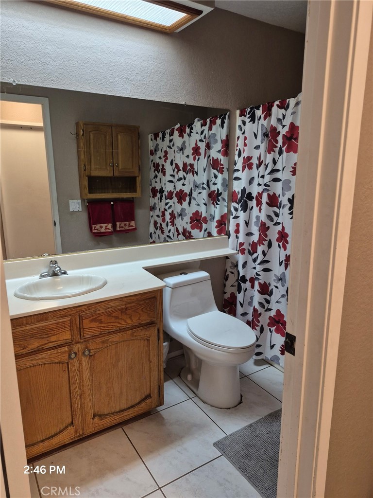 15246 Chaparral Way Victorville, CA 92394 - Photo 6 of 6 a bathroom with a sink toilet and shower