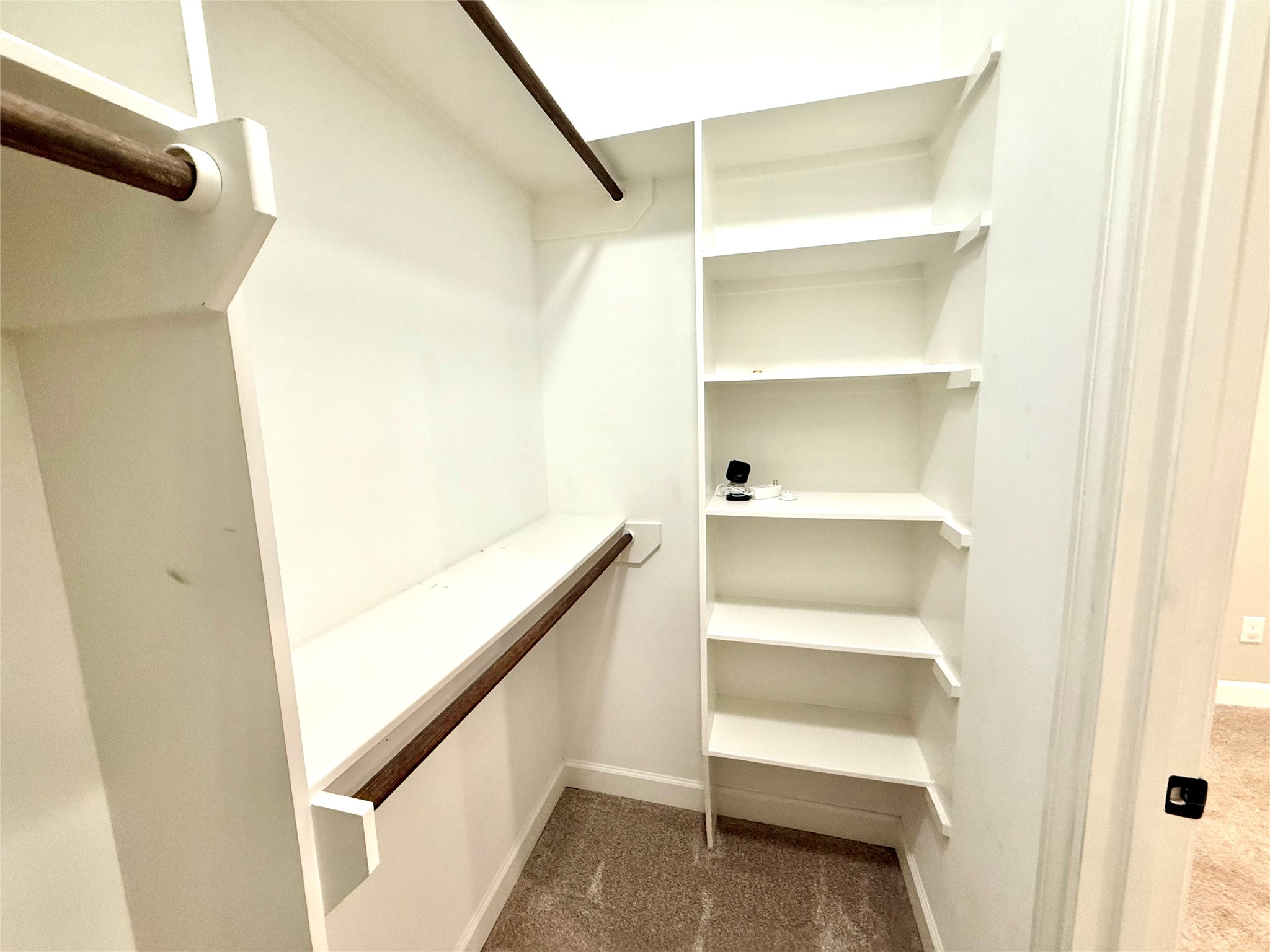 9206 Anna Street Needville, TX 77461 - Photo 13 of 24 a view of walk in closet with empty racks