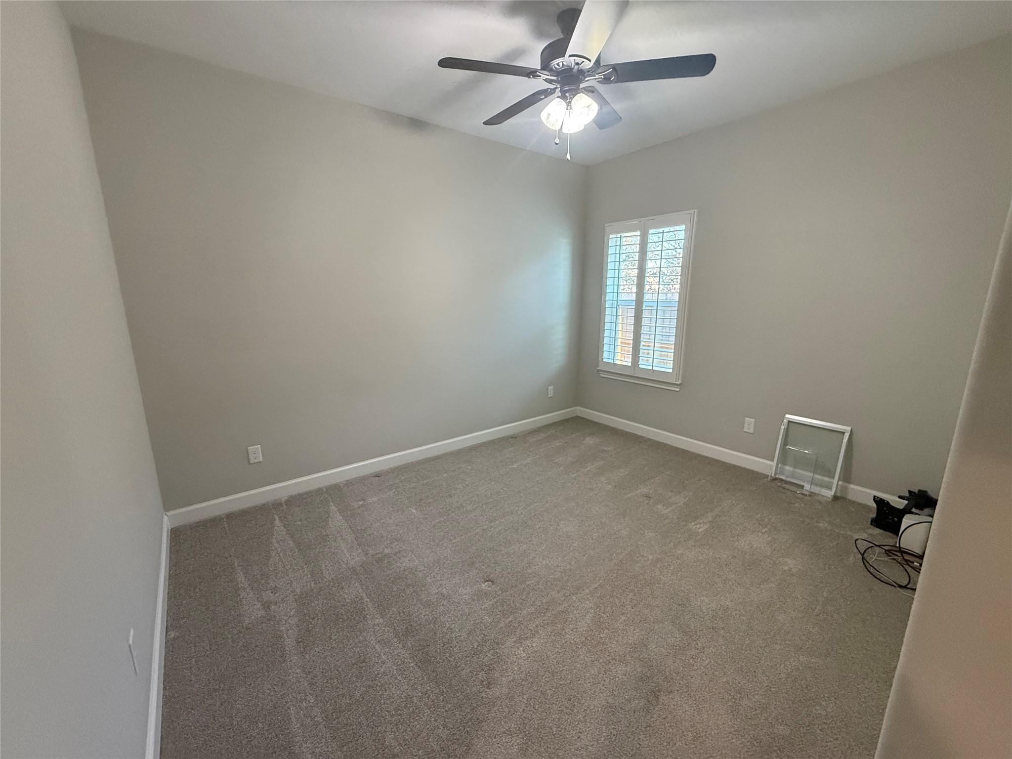 9206 Anna Street Needville, TX 77461 - Photo 14 of 24 an empty room with a window and a fan