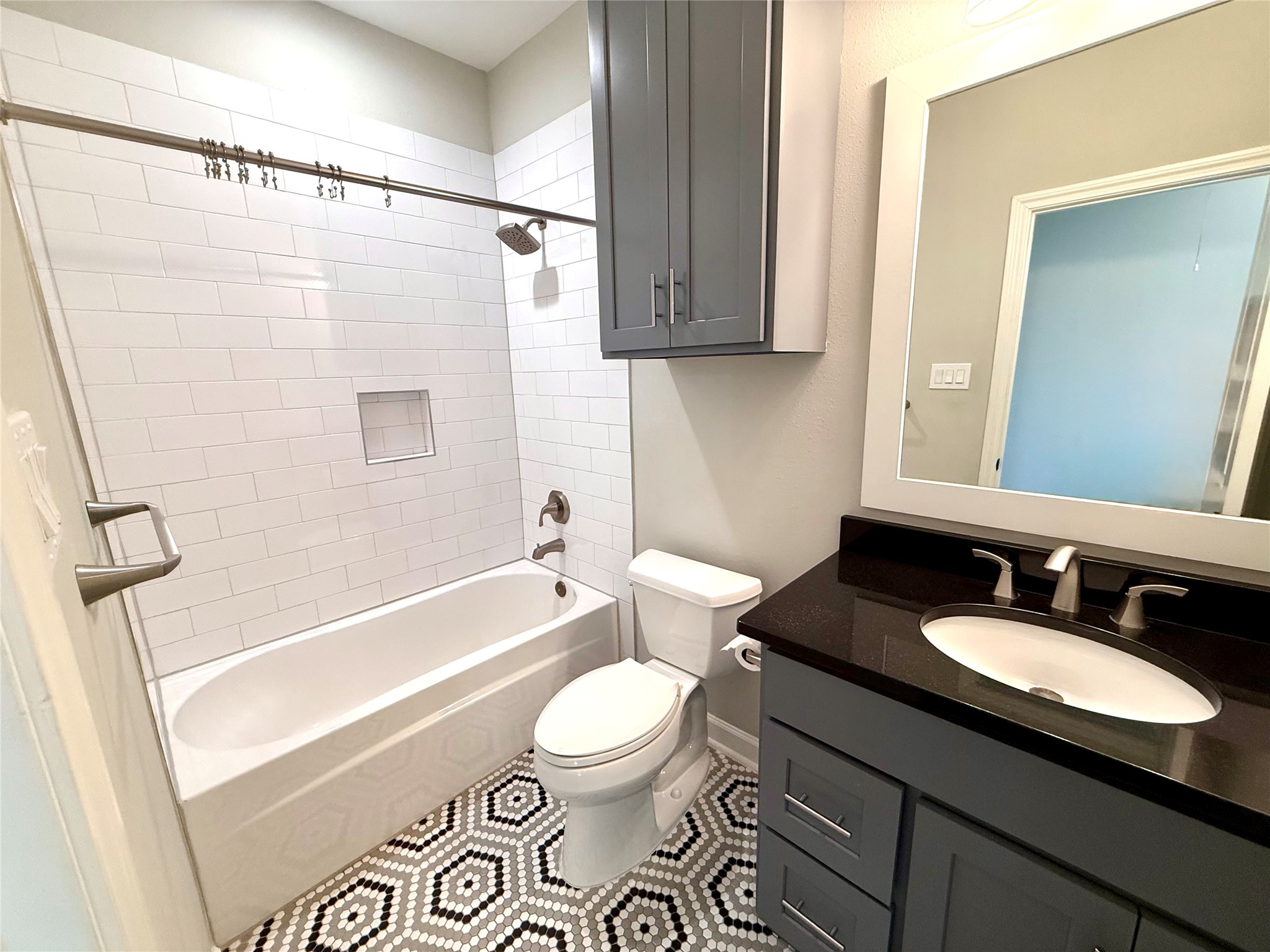 9206 Anna Street Needville, TX 77461 - Photo 17 of 24 a bathroom with a double vanity sink toilet mirror and shower