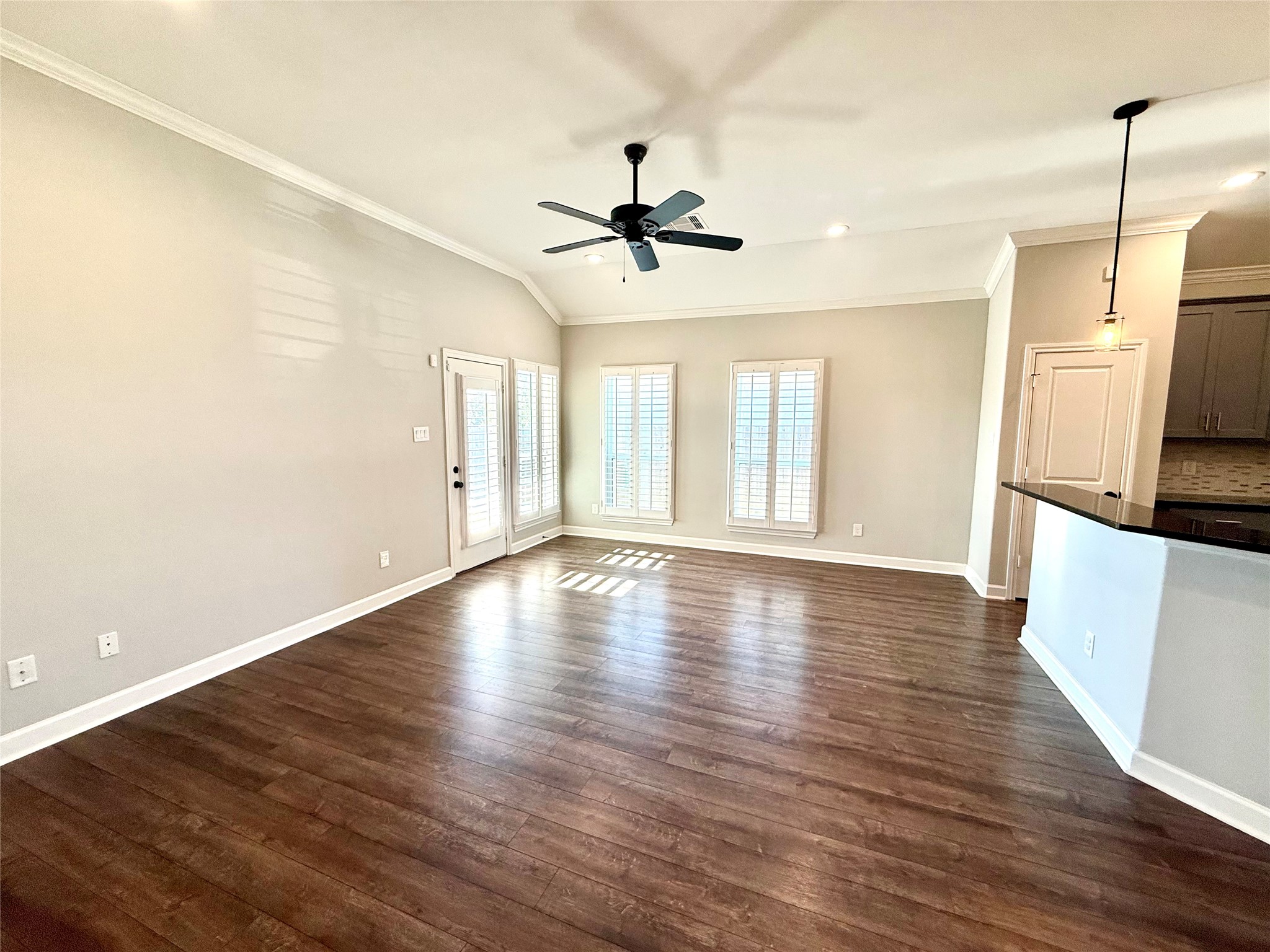 9206 Anna Street Needville, TX 77461 - Photo 8 of 24 a view of a kitchen with wooden floor and a ceiling fan