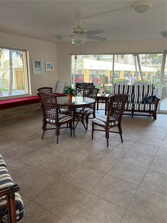 4725 Cove Circle, Unit 104 Madeira Beach, FL 33708 - Photo 21 of 22 a dining room with furniture and a large window