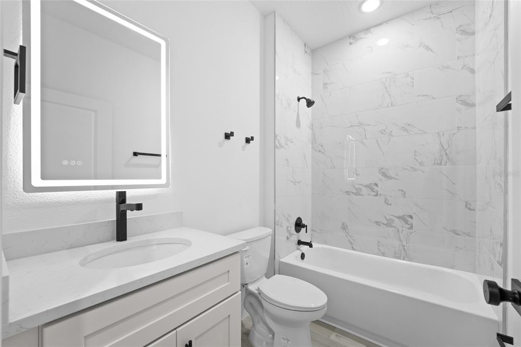 4450 Badali Road North Port, FL 34286 - Photo 13 of 28 a bathroom with a sink a toilet and a bathtub