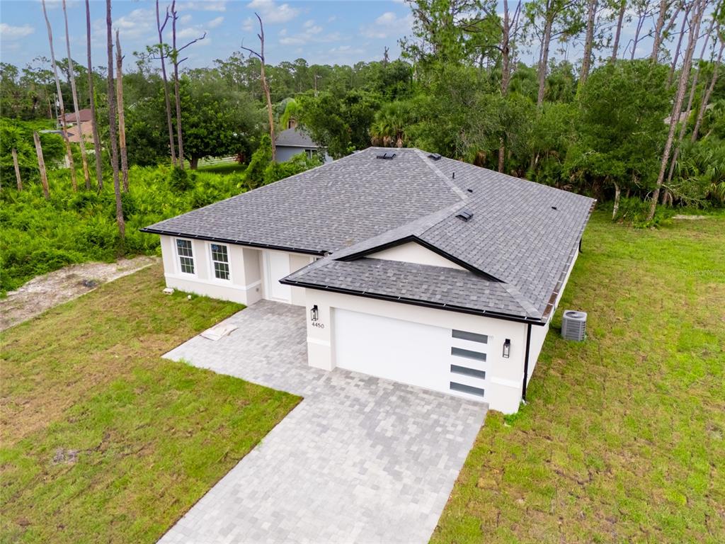 4450 Badali Road North Port, FL 34286 - Photo 19 of 28 a aerial view of a house next to a yard with big trees