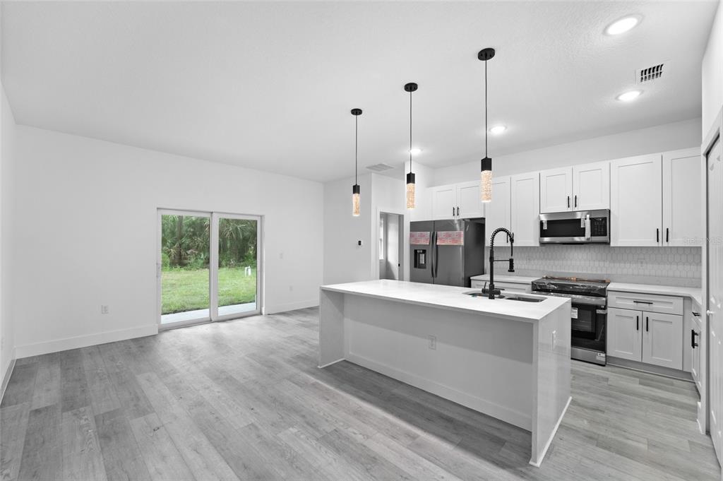 4450 Badali Road North Port, FL 34286 - Photo 3 of 28 a view of a kitchen with furniture and wooden floor