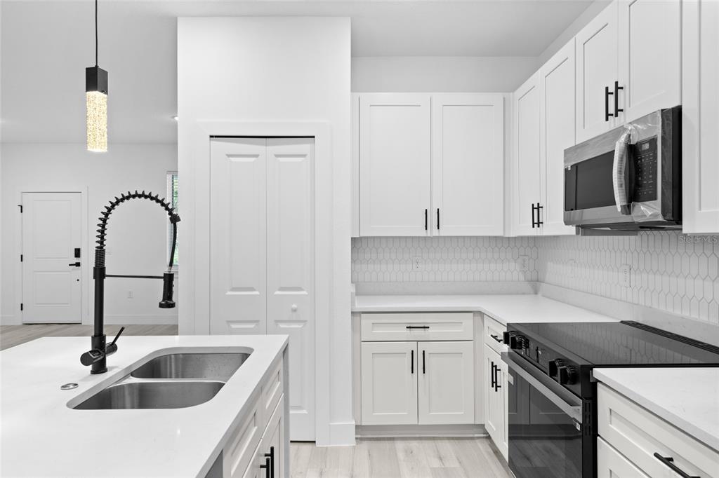 4450 Badali Road North Port, FL 34286 - Photo 6 of 28 a kitchen with a sink cabinets and appliances