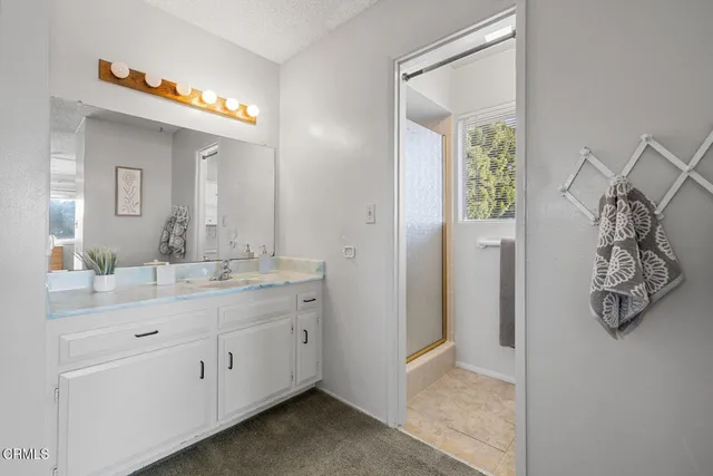 a bedroom with a bed and a baby bed