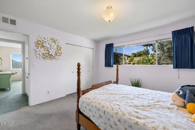 a living room with furniture a window and a clock